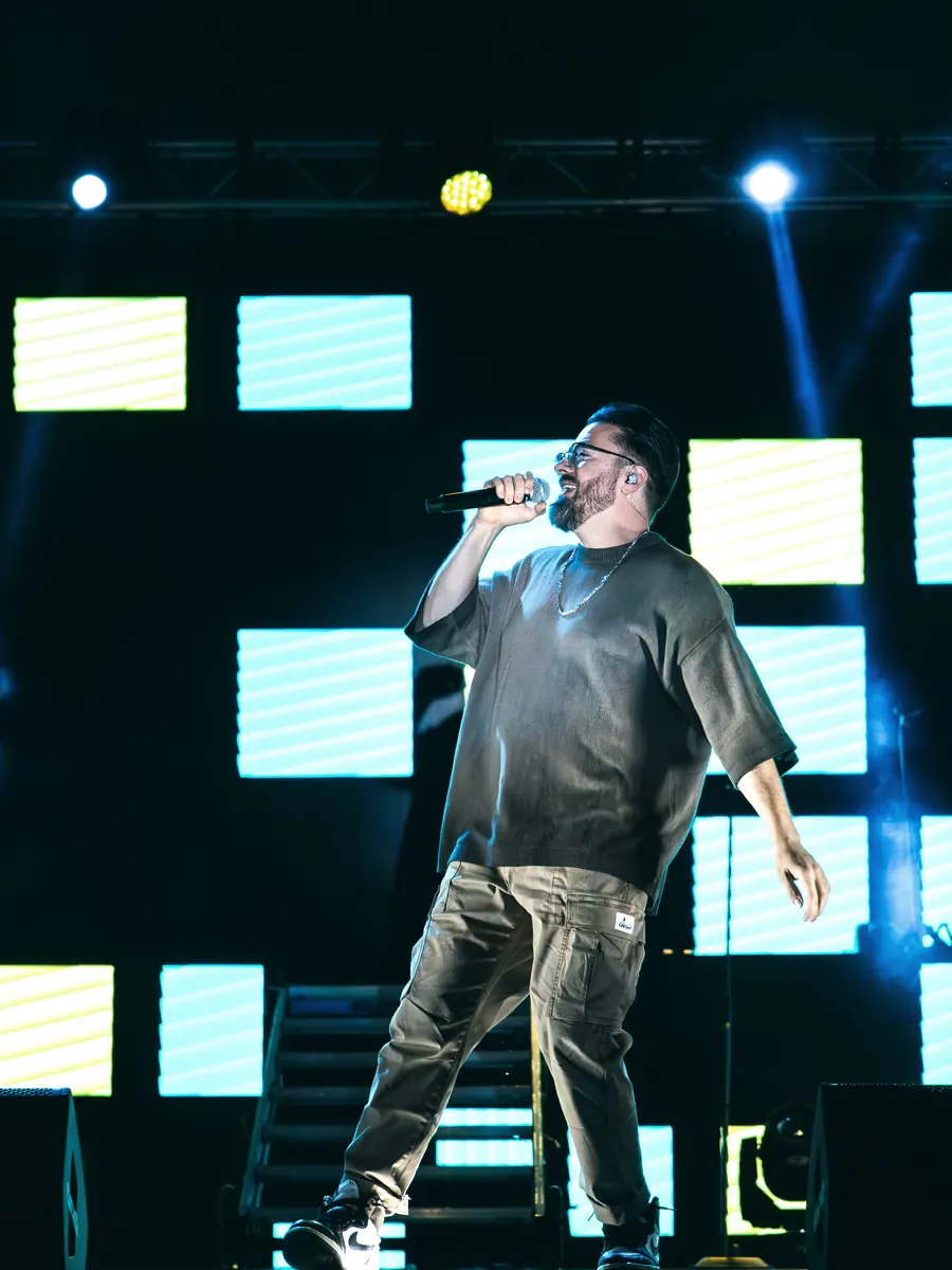 Artist performing against a tiled LED backdrop