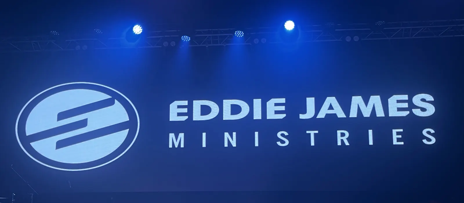 Ministry logo rendered edge-to-edge on a LUXLED wall